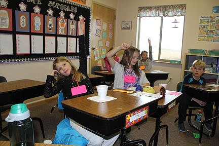 &lt;p&gt;Ara, left, and Scout raise their hands so they can ask grandparents questions about their days in school. Vince Lovato / Leader photo&lt;/p&gt;