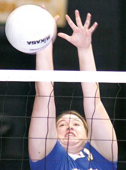 Jenna Cederberg for The Western News Katie Emery goes high for a block. Emery had three blocks against Billings Central.