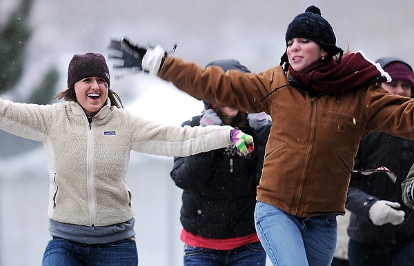 Beth Beechie, left, and Jenny Muscat, both students at the University of Montana dance excitedly as they make their way to the student section for 110th Cat/Griz game on Saturday, November 20, in Missoula.