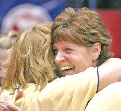 Jenna Cederberg for The Western News Assistant coach Barb Mee hugs head coach Cindy Ostrem-Johnston during the thrill of victory.