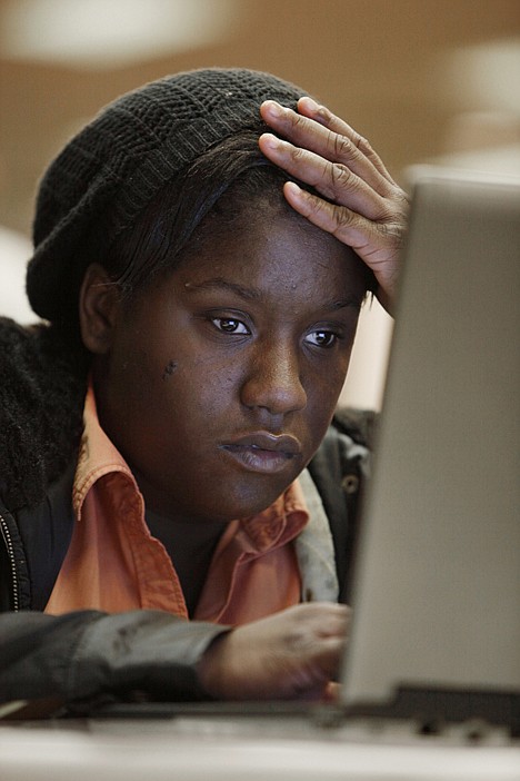 &lt;p&gt;In this Nov. 10 photo, job seeker Carlesha Clay views online job postings while attending a job fair in Livonia, Mich.&lt;/p&gt;