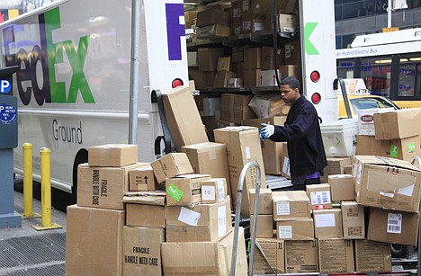 &lt;p&gt;A FedEx employee sorts packages next to his truck Tuesday in New York. The holiday season is the busiest of the year for the Memphis-based delivery company. Americans loosened the grips on their wallets and spent more last month, a hopeful sign as shoppers head into the holiday buying season.&lt;/p&gt;