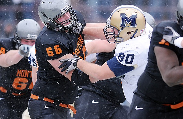 Grizzly offensive lineman Russell Piette (66) and Bobcat defensive tackle Dan Ogden (90) face off during the first quarter of their game on Saturday in Missoula.