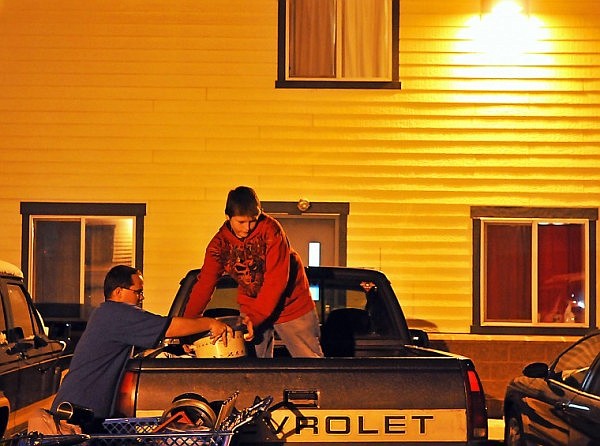 William and Robert work together to pack up the back of their pickup truck as they move out of Samaritan House.