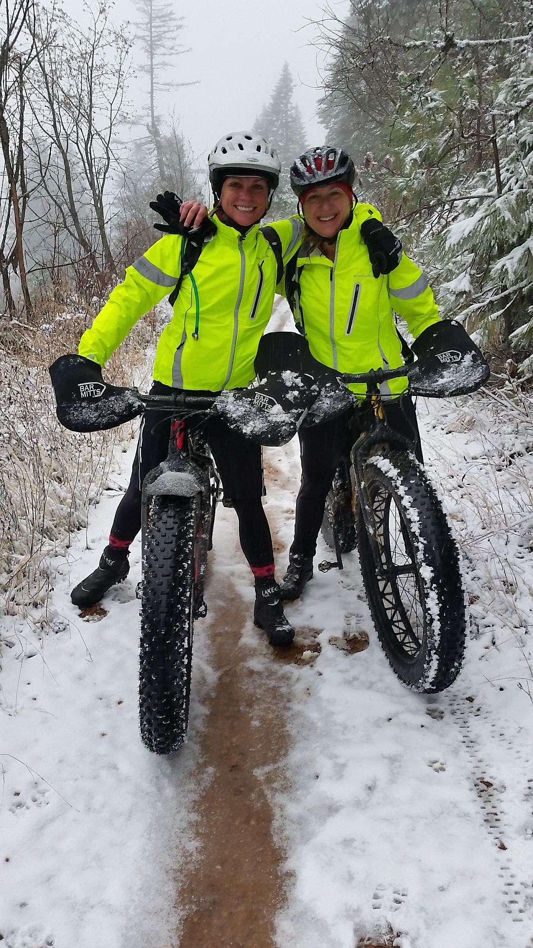 <p>Molly Obetz, left, and Jen Fletcher of Dalton Gardens pause during a fat bike trip on Schweitzer Mountain last winter.</p>