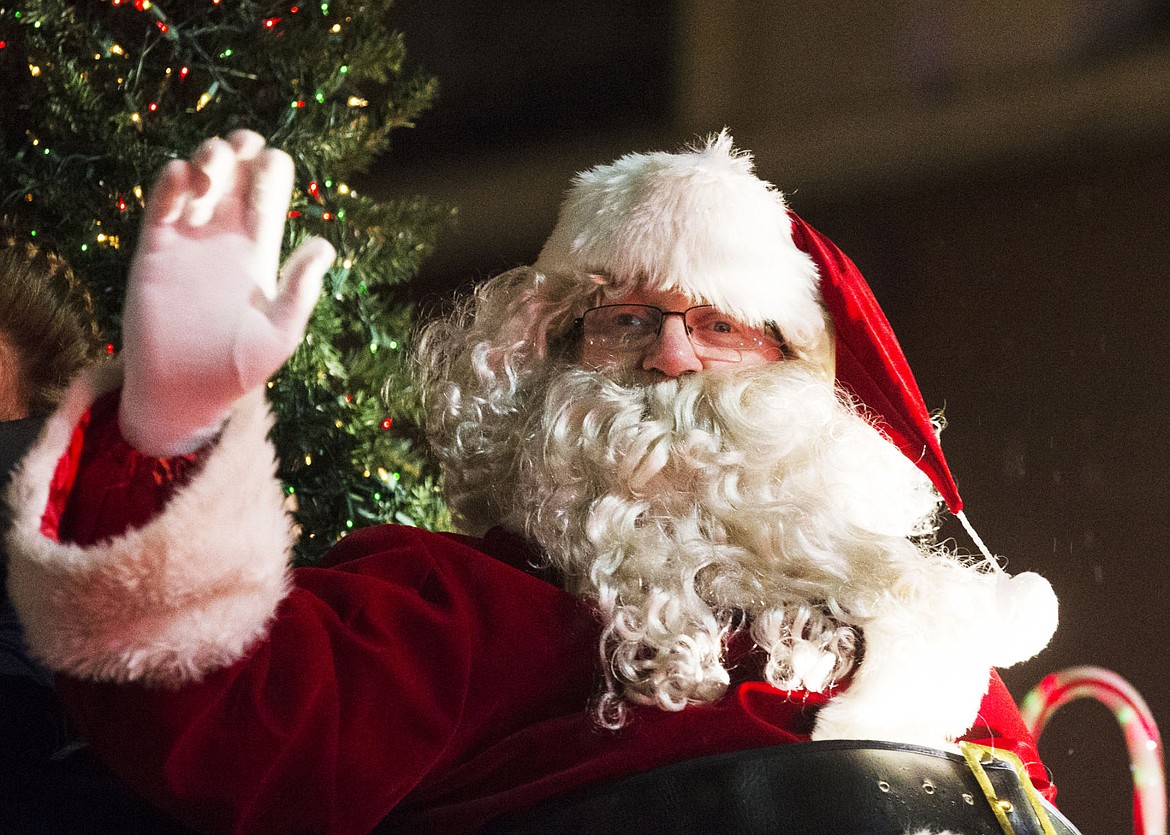 &lt;p&gt;Santa Claus waves from his firetruck &quot;sleigh&quot; to some 30,000 people lining Sherman Avenue at the holiday parade preceding the Coeur d'Alene Resort Holiday Light Show Friday night.&lt;/p&gt;