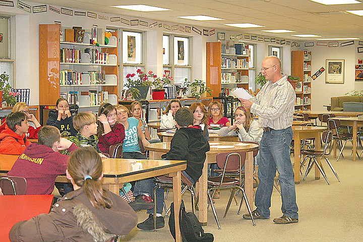 Sixth grade teacher Matthew Krogh speaks with members of The
Brave Challenge at Chief Moses Middle School. The students planned
to write letters thanking teachers at the school.