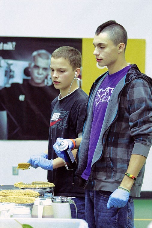 Shad Rich and Thomas Spencer served up pumpkin pie and whipped cream last week at the Thanksgiving Dinner that the community shared with St. Regis Schools.