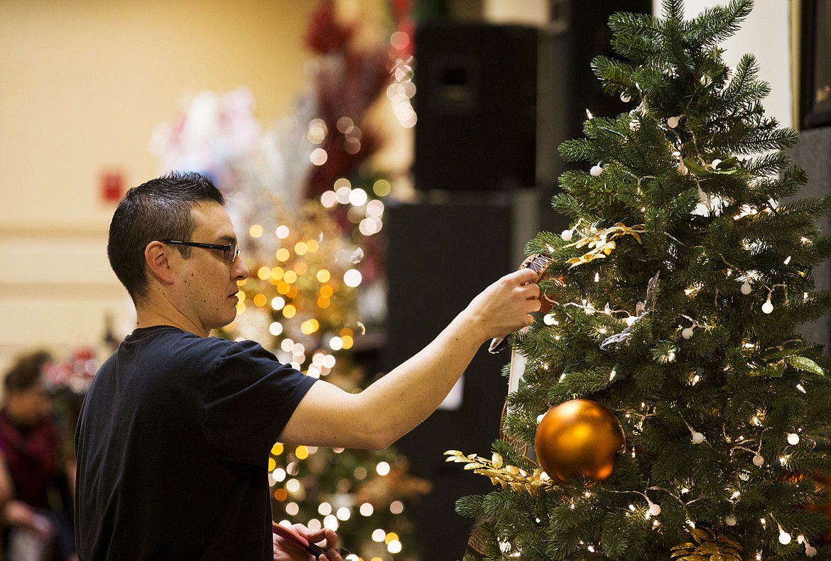 &lt;p&gt;Michael Hairychin hangs a drum on the Coeur d'Alene Casino's Christmas Tree in preparation for Festival of Trees on Friday at the Coeur d'Alene Resort.&lt;/p&gt;