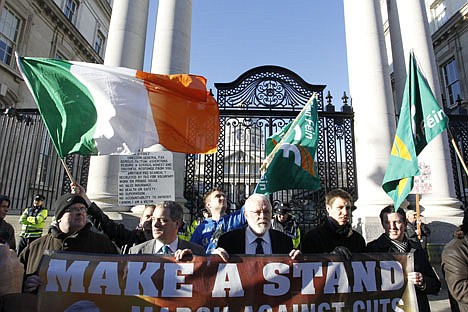 &lt;p&gt;Sinn Fein supporters protest outside Irish government buildings, in Dublin, Ireland, Wednesday, Nov. 24, 2010. The Irish government has unveiled a range of tough austerity measures designed to help solve the country's debt crisis, among the spending cuts and tax rises are a reduction in the minimum wage, a new property tax and thousands of public sector job cuts. The four-year plan is designed to save the state 15 billion euro ($20bn;&lt;/p&gt;