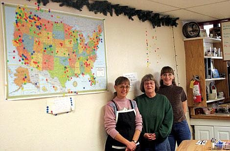 Heather Hasty/Valley Press Heather Copp, Char Johnson and Carmin Wilmer show off the famous map.