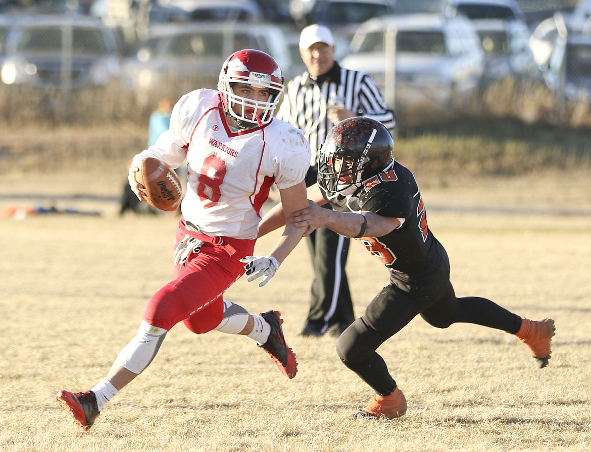 &lt;p&gt;Tyler Tanner looks for an open reciever during the fourth quarter of Arlee's game against Chinook.&lt;/p&gt;