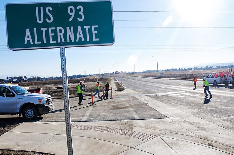 &lt;p&gt;Road crew members remove traffic cones Thursday morning blocking the entrance to the U.S. 93 Alternate Route from Reserve Loop. The newest section of the U.S. 93 bypass opened to public traffic at around noon on Thursday. Nov. 21, 2013 in Kalispell, Montana. (Patrick Cote/Daily Inter Lake)&lt;/p&gt;