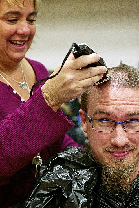 &lt;p&gt;JEROME A. POLLOS/Press Bruce Twitchell, the photography teacher at Coeur d'Alene High, has his head shaved by Kiersten Kerr, the school's librarian, during an assembly Wednesday. Student and school staff offered their hair as motivation for a fundraising effort called &quot;The Mane Event&quot; held by students to benefit the Viking Vault. The Vault benefits needy students at CHS, the money will go to buy clothes, shoes, toiletries, etc.&#160;The effort raised $1,528.&lt;/p&gt;