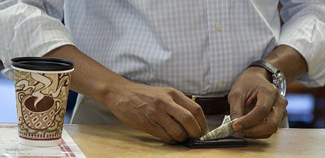 &lt;p&gt;This Aug. 14, 2012, photo shows President Barack Obama paying for his coffee and muffins at the Coffee Connection in Knoxville, Iowa.&lt;/p&gt;