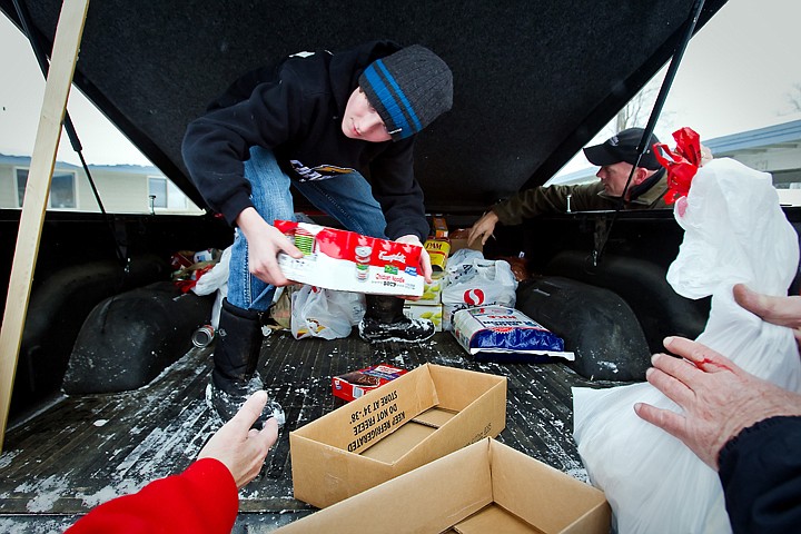 &lt;p&gt;JEROME A. POLLOS/Press Tyler Briner, 13, and his father Chris Briner, right, unload one of the four vehicles Tuesday used to transport the estimated 6,000 pounds of food the Coeur d'Alene Charter Academy collected for a donation to St. Vincent de Paul North Idaho.&lt;/p&gt;