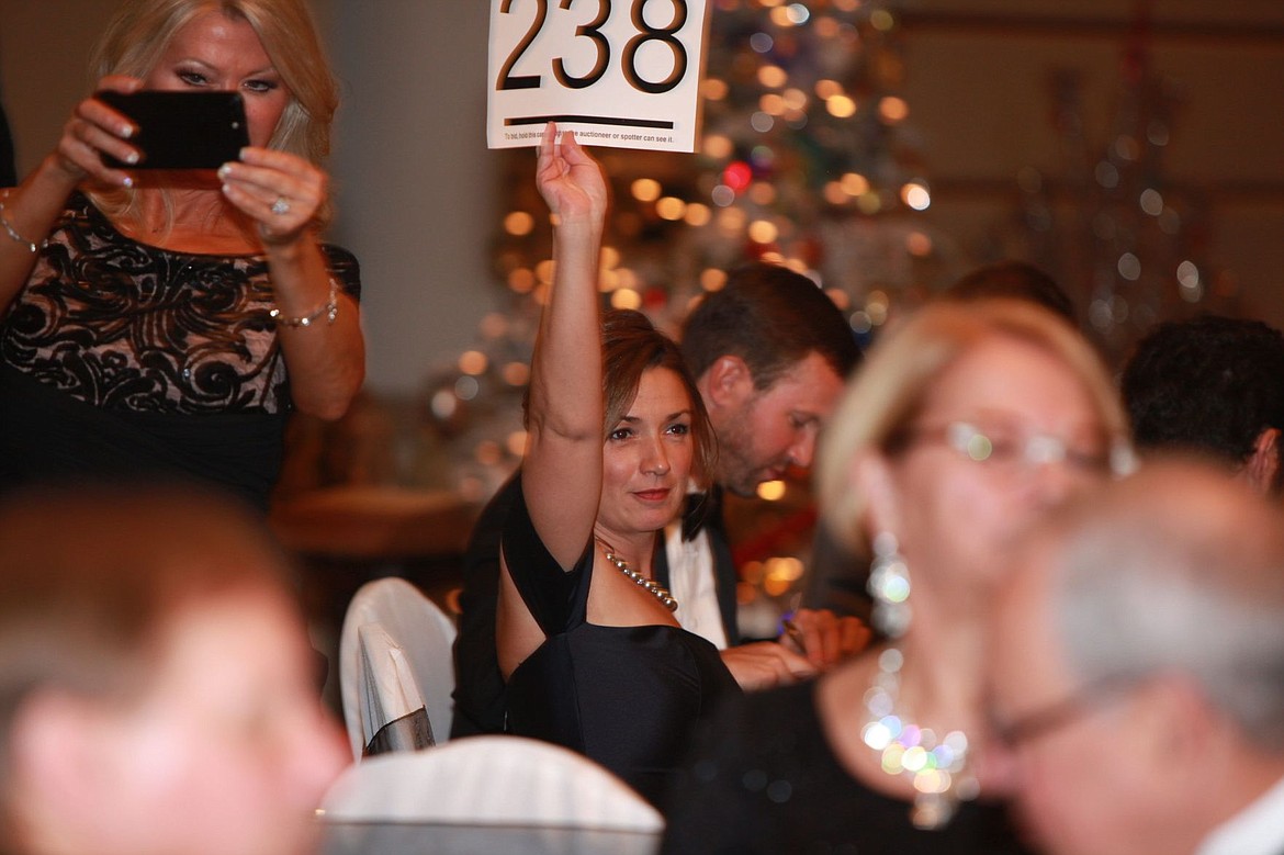 &lt;p&gt;Photo courtesy of Sheena Dunn&lt;/p&gt;&lt;p&gt;Sara Meyer holds up an auction number Saturday evening during the 28th annual Festival of Trees Gala in The Coeur d'Alene Resort. Gala auctions raised more than $285,000 to expand Kootenai Health's emergency department and operating rooms.&lt;/p&gt;