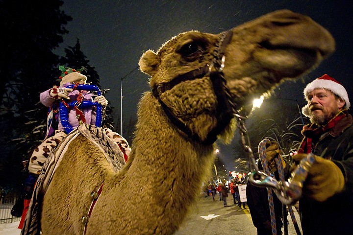 &lt;p&gt;Kevin Hecket positions Dino the camel as Miranda Hoekstra, 4, and her sister Brianna, 8, ride on top with the Mountain View Veterinary Clinic's parade entry.&lt;/p&gt;