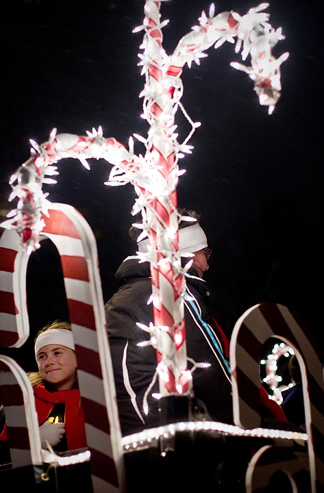 &lt;p&gt;Emma James waits for the parade to start as she peeks through the candy canes on the Lutheran Academy of the Master float.&lt;/p&gt;