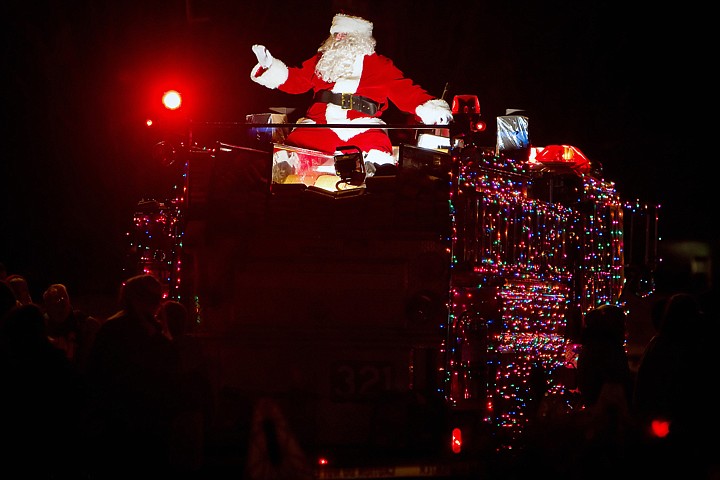 &lt;p&gt;Santa Claus waves to the crowd as he rides atop a Coeur d'Alene Fire engine.&lt;/p&gt;