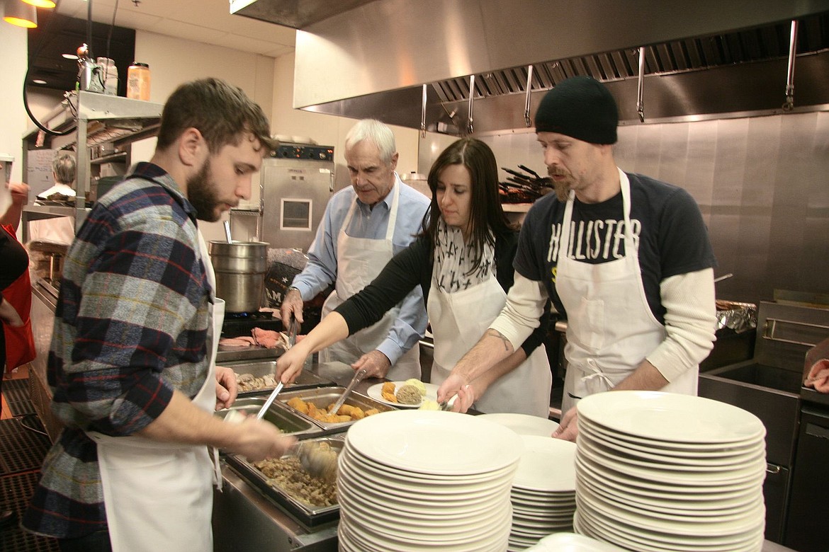 &lt;p&gt;John Fowler of Lewiston, left, Josh and Nicole Tallmadge of Coeur d'Alene, right, and Jonathan Sedgwick of Coeur d'Alene serve up stuffing, green beans, sweet potatoes and other Thanksgiving goodies Thursday during Fedora Pub and Grille's fifth annual free community Thanksgiving dinner.&lt;/p&gt;