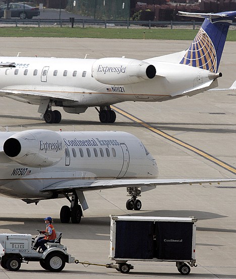 &lt;p&gt;Two Continental Express airplanes taxi toward the runway as a baggage handler moves baggage, in Cleveland on Oct. 10. To fight high fuel prices, airlines are getting rid of their least-efficient planes, the small jets that connect America's smaller cities to the rest of the world.&lt;/p&gt;