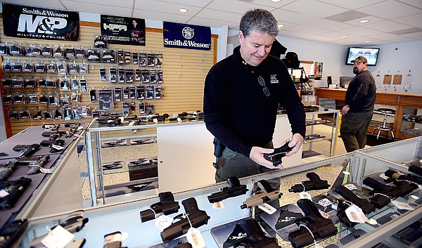 &lt;p&gt;Doug Davis, assistant manager of sales, prepares to open the store on Nov. 13 at Northwest Shooter on U.S. &#160;2 southwest of Columbia Falls.&lt;/p&gt;