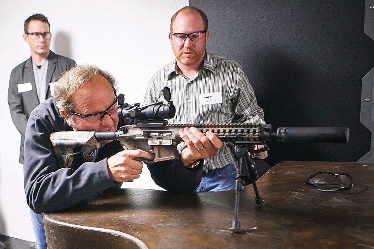 &lt;p&gt;Gov. Brian Schweitzer checks the sights of an AR-15 before firing it at a small indoor range during the open house Nov. 16 for Proof Research north of Kalispell.&lt;/p&gt;