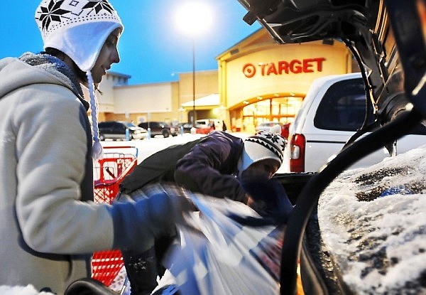 Kate Wallway, left, works with Jessica Lyman work to fit in their last remaining purchases from early morning shopping on Friday morning. The two began their shopping at midnight at Wal-Mart and finished at Target just as daylight began arriving.