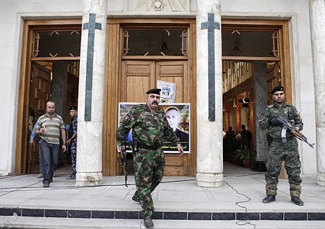 &lt;p&gt;Iraqi security forces stand guard during a mass at Our Lady of Salvation church in Baghdad, Iraq, on Nov. 7.&lt;/p&gt;