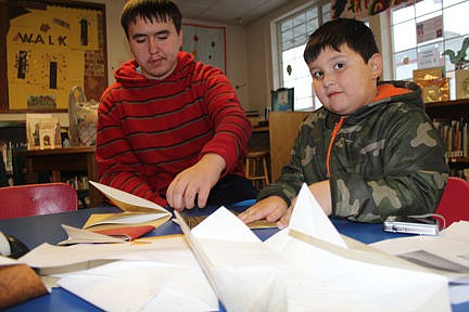 &lt;p&gt;Nathan, 5, gets some help from his brother, Jules, 14, of Charlo, during the Ronan&#146;s Library&#146;s 100th anniversary celebration Friday.&lt;/p&gt;