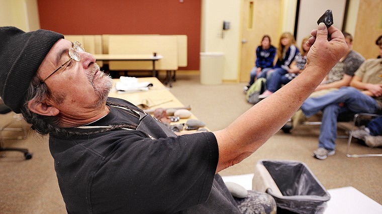 Dwight Billeadeau discusses the properties of obsidian rock, a volcanic glass, during his demonstration on native ancestral tools on Tuesday at First People Day at Glacier High School. Billeadeau, 62, told the students he has been making arrowheads since he was 10 years old. First People Day featured presentations, song, dance, storytelling and native games led by American Indian educators and elders.