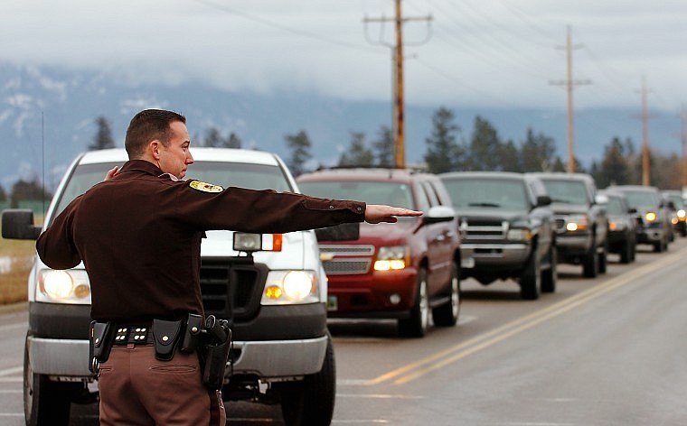 Flathead County Sheriff&#146;s Deputy Nelson Grant, above, directs traffic from West Reserve Drive onto Whitefish Stage Road on Tuesday afternoon while West Reserve was closed for repair of a downed power line.