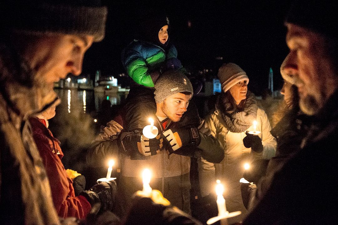 &lt;p&gt;The Boland family, from Coeur d'Alene and California, light holiday candles on the City Park Beach as they await the Coeur d'Alene Resort Holiday Light Show firework display on Friday in Coeur d'Alene.&lt;/p&gt;