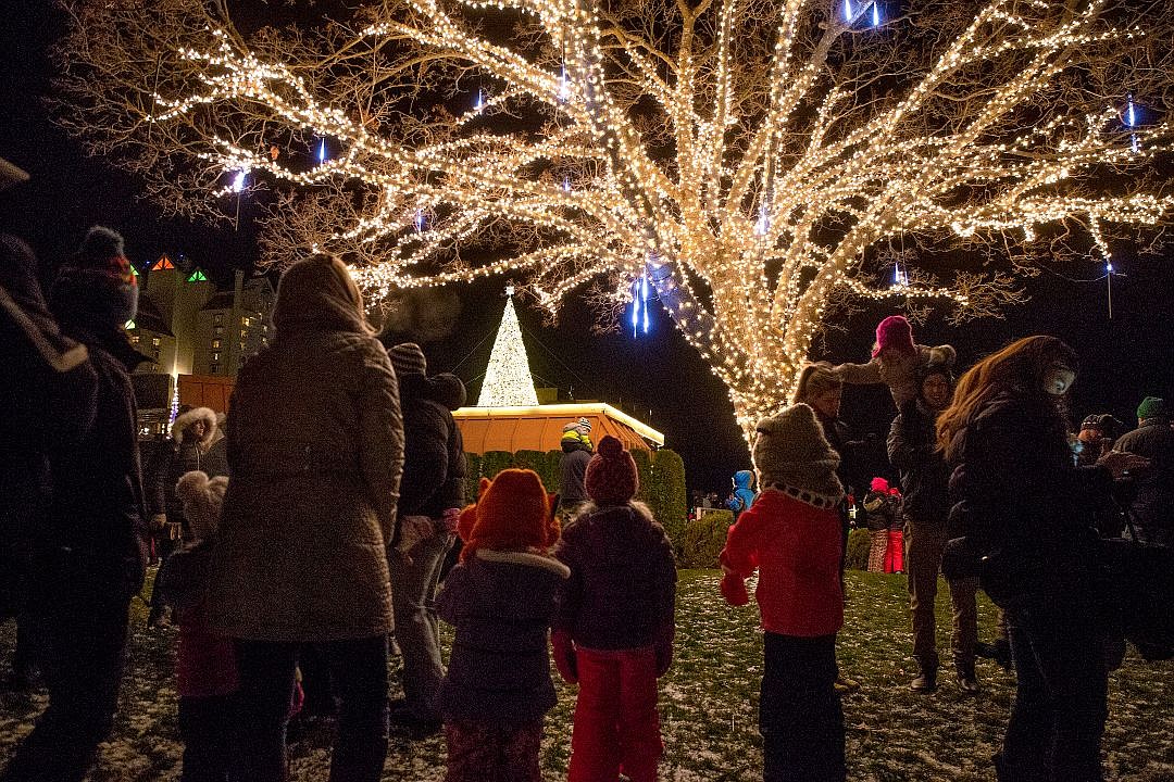 &lt;p&gt;Families gather underneath a fully lit-up tree as the Christmas tree atop the Hagadone Corporate Offices stands out against the night sky in the distance on Friday at the Coeur d'Alene Resort Holiday Light Show.&lt;/p&gt;