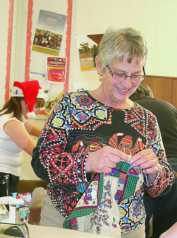 &lt;p&gt;Kay Nygaard gets ready to iron one of the dozens of stockings the Plains Woman's Club made on Friday. The organization teamed up with Sanders County Coalition for FAmilies in an effort to bring Christmas joy to those in need.&lt;/p&gt;