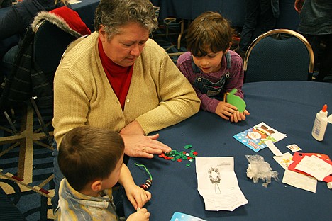 &lt;p&gt;Cindy DuPuis, center, of Hayden, helps her grandchildren pick out buttons for a craft project on Sunday at the Coeur d'Alene Pediatrics Children's Workshop. Jory Moore, 3, left, and 5-year-old Emjay Reed, right, both participated in the workshop.&lt;/p&gt;