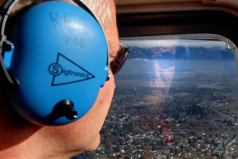 Jim Bob Pierce, owner of Red Eagle Aviation, looks out over Kalispell while flying on Wednesday. &#147;The people of Kalispell should embrace that,&#148; Pierce said of Kalispell City Airport. &#147;They have a captive audience where it guarantees that people who are coming here are going to be in Kalispell for sure.&#148;