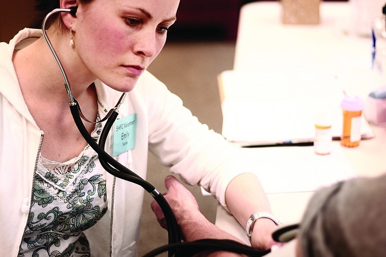 &lt;p&gt;Emily Nichols, a volunteer registered nurse, cares for a patient
at the Shepherd&#146;s Hand free clinic in Whitefish.&lt;/p&gt;