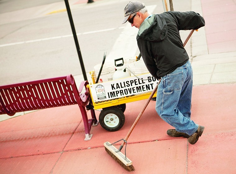 &lt;p&gt;Paul Faessel sweeps the sidewalk on the corner of 1st Avenue
West in downtown Kalispell earlier this year.&lt;/p&gt;