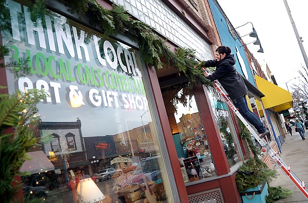 &lt;p&gt;Cathi Spence of Think Local hangs lights and greenery at her
Main Street shop on Tuesday afternoon in Kalispell. Think Local is
open from 10 a.m. to 7 p.m. every day until Christmas Eve.&lt;/p&gt;