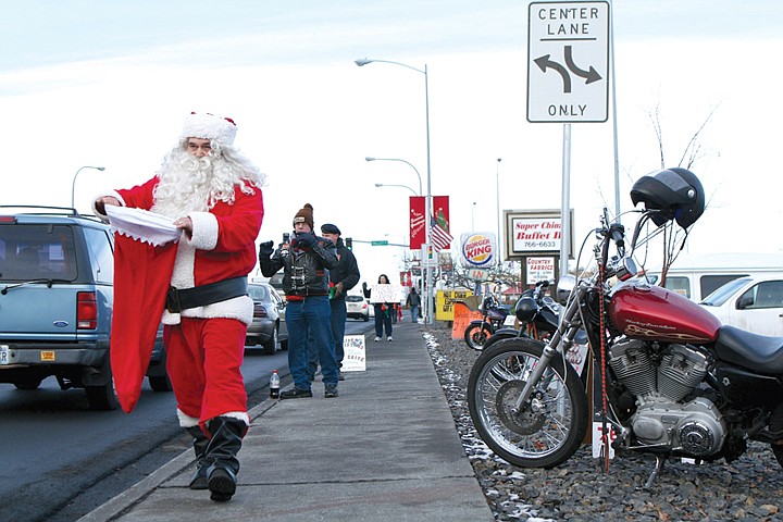 Members of the Unchained Brotherhood collected money and toy
donations during their second annual holiday toy drive in Moses
Lake.