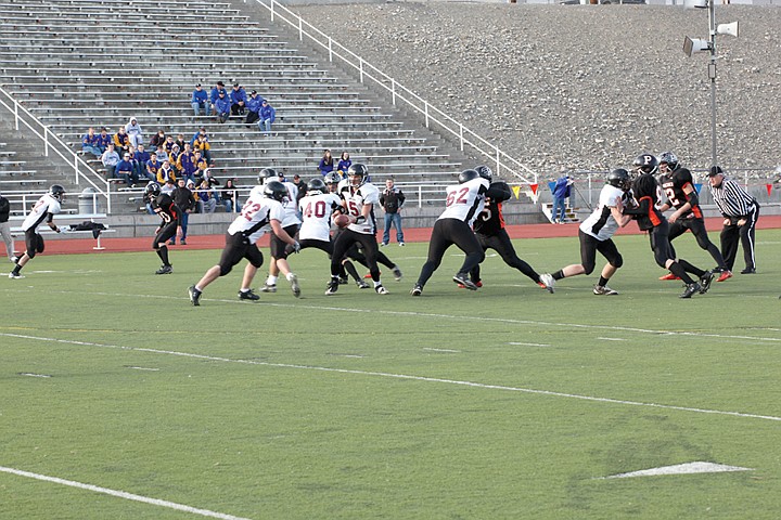 ACH quarterback Derek Isaak hands off to Warriors running back
Brock Streeter in the game against Pomeroy Saturday.