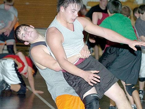 Zach Urness/Leader - Bryce Greenfield works on a throwing move against Marcus Schiele at practice on Monday. Both will battle to make the starting lineup.