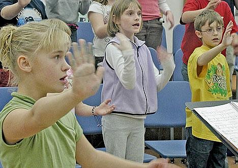 Libby Middle School Select Choir members, from left, Taylor Resch, Mahalah Wedel and Luke Adamson practice for their Dec. 1 debut performance.