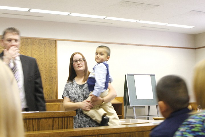 Samantha Bradley, of Moses Lake, holds her son, Nathanael, 2,
during his adoption at the Grant County Courthouse.