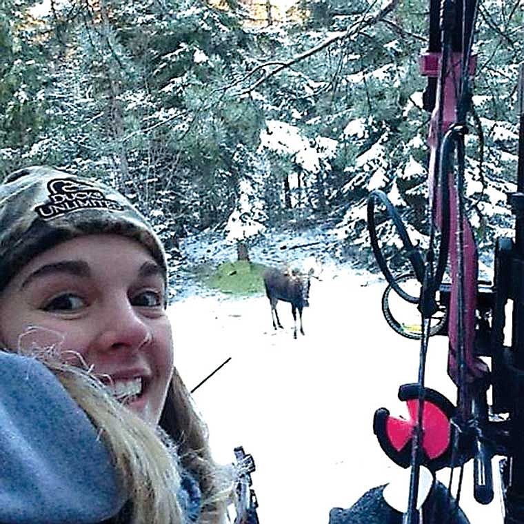 Taylor Shafer takes a picture with a moose while hunting.