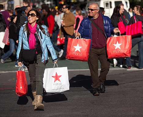 &lt;p&gt;FILE - In this Nov. 25, 2011 file photo, consumers lug their bags through Herald Square during the busiest shopping day of the year, in New York. A private research group says consumer?s confidence in the economy in November soared 15 points to its highest level since July. The report was encouraging news for the holiday shopping season. (AP Photo/John Minchillo File)&lt;/p&gt;