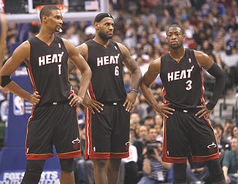 &lt;p&gt;Miami Heat forward Chris Bosh (1), forward LeBron James (6) and shooting guard Dwyane Wade look on during the second half of a game Saturday against the Mavericks in Dallas. Dallas won 106-92.&lt;/p&gt;