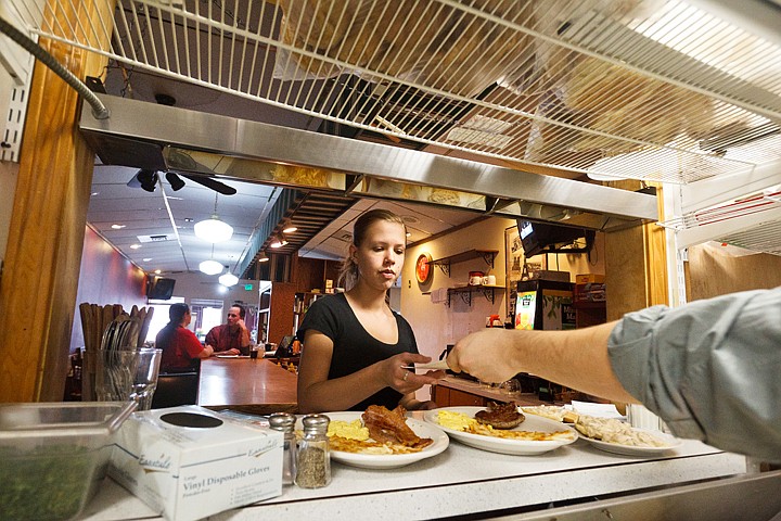 &lt;p&gt;SHAWN GUST/Press Amanda Cobb, a server at Grandma Zula's Kitchen, takes a ticket from the kitchen staff before delivering an order during her shift Tuesday at the new Post Falls restaurant.&lt;/p&gt;